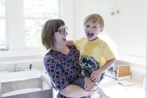 Mother Holding Son Mother holding son in kitchen