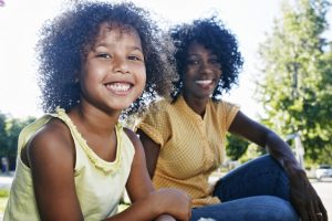 Mother and daughter smiling Mother and daughter smiling outdoors