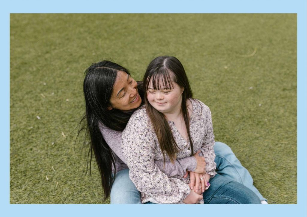 15 Mother and daughter with Downs syndrome cuddling and smiling