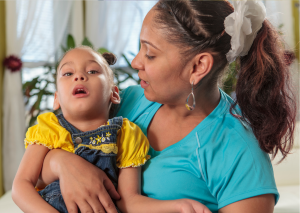 Adult woman smiles at girl child.